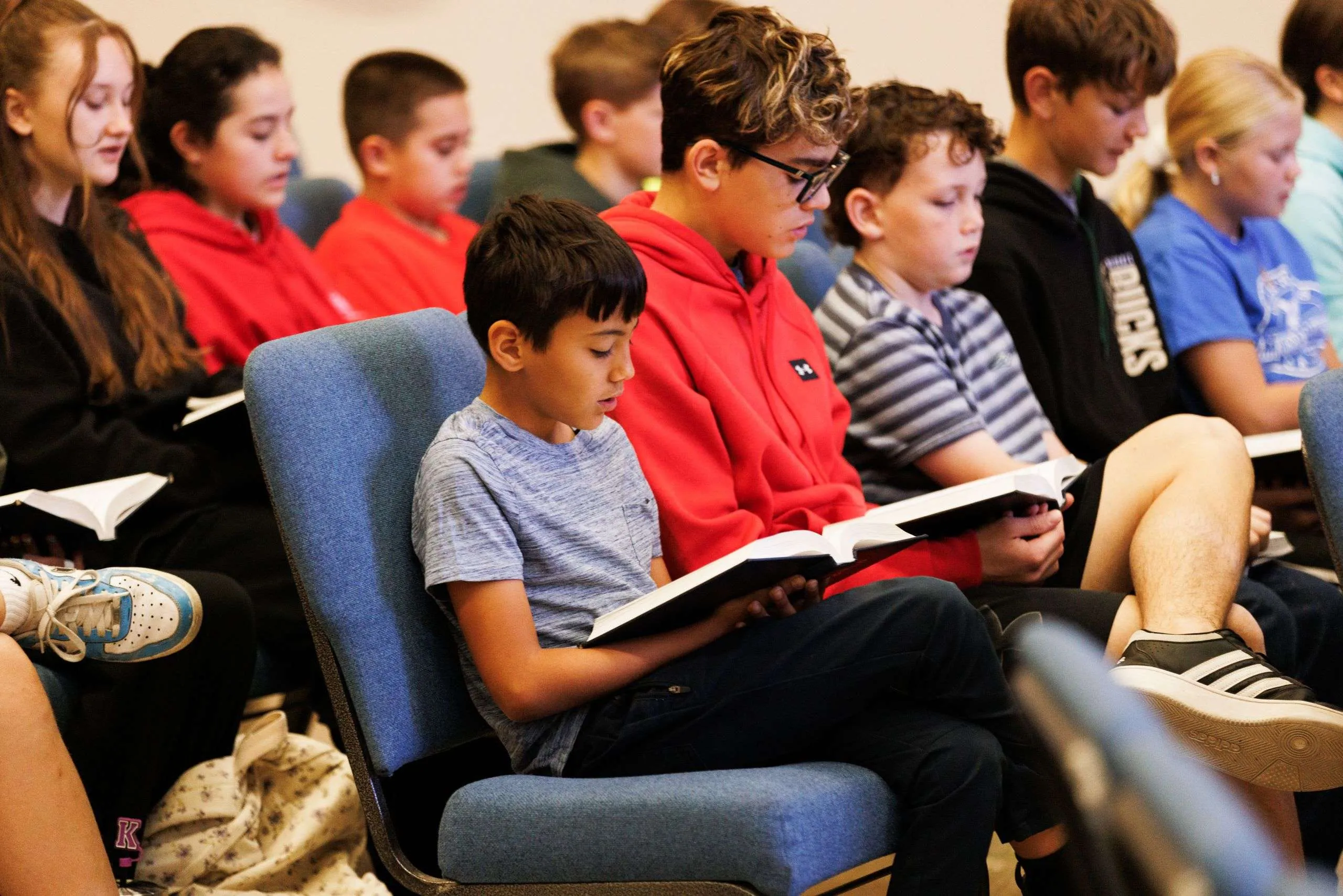 Elementary and Junior High Chapel Reading Elementary and junior high boys sit in chapel following along in open books